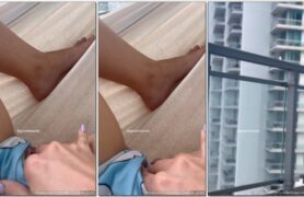 Grazi Mourão se tocando na sacada do prédio