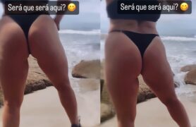 Menina de máscara com biquíni enfiado na bunda grande na praia